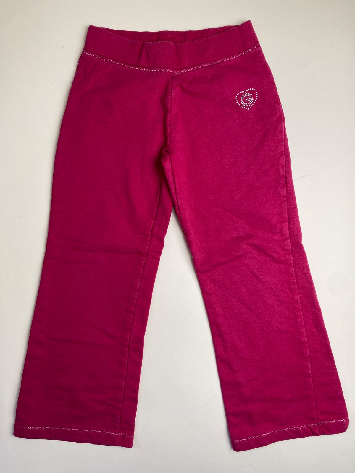 Pantaloni sportivi fucsia per bambina con cuore di strass