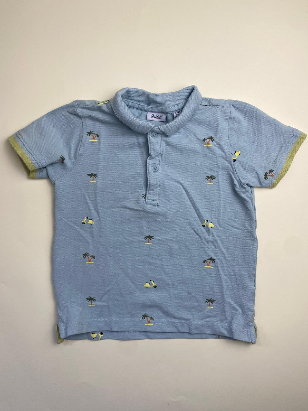 Polo bambino azzurra con palme e scooter