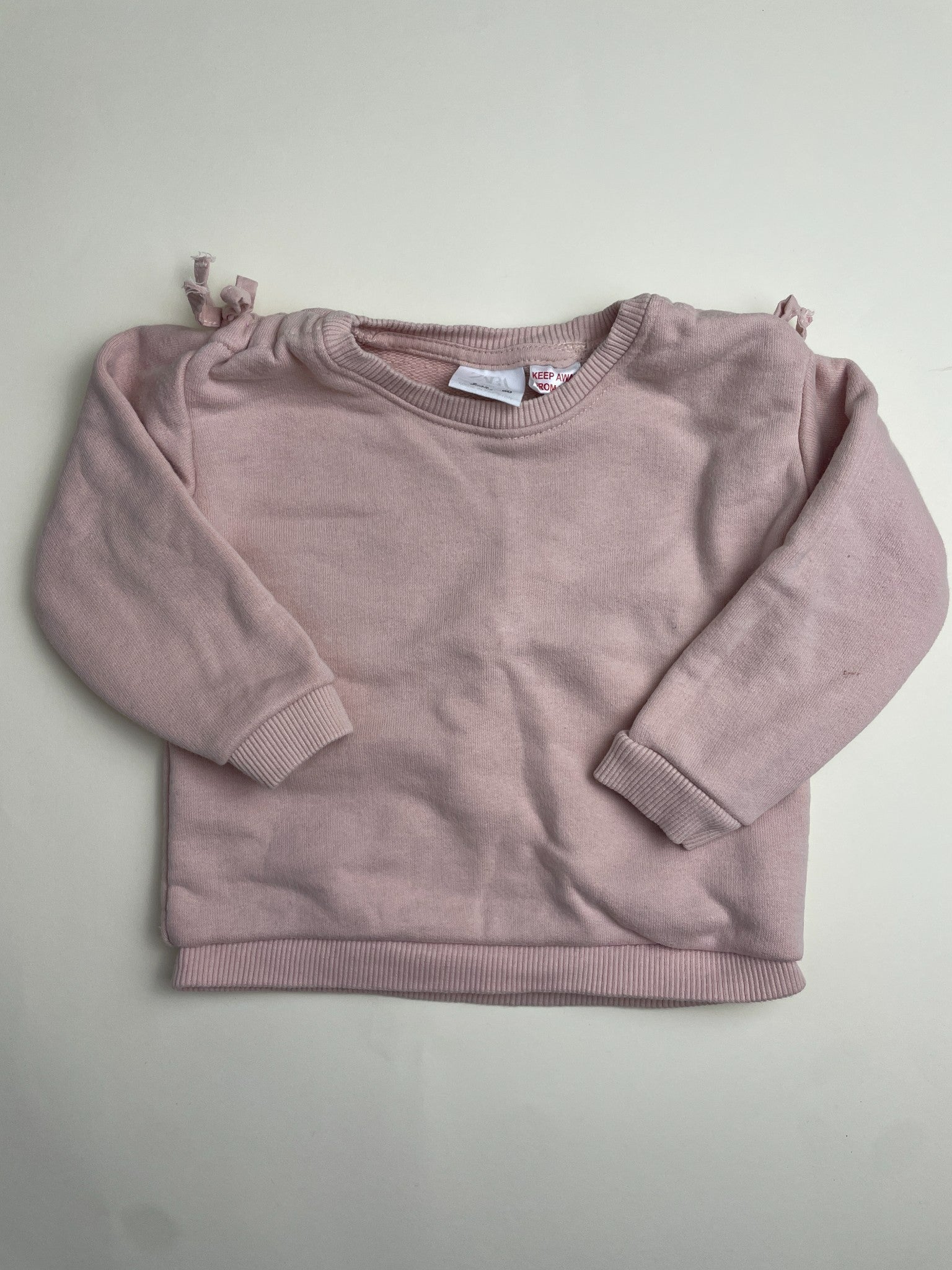 Felpa rosa chiaro con fiocchi sulle spalle