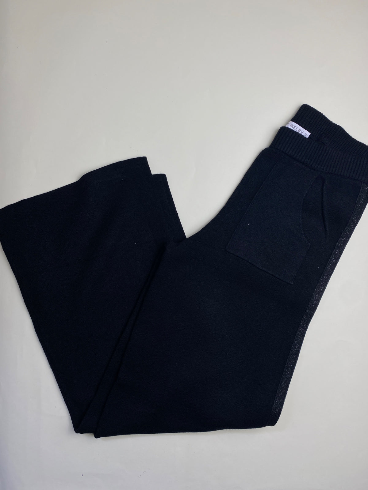 Pantaloni a palazzo in maglia neri con banda glitter