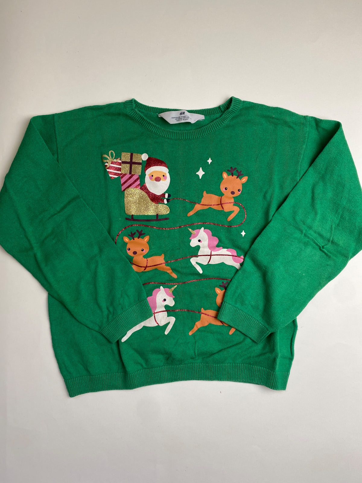 Maglione natalizio H&M verde con Babbo Natale, renne e unicorni