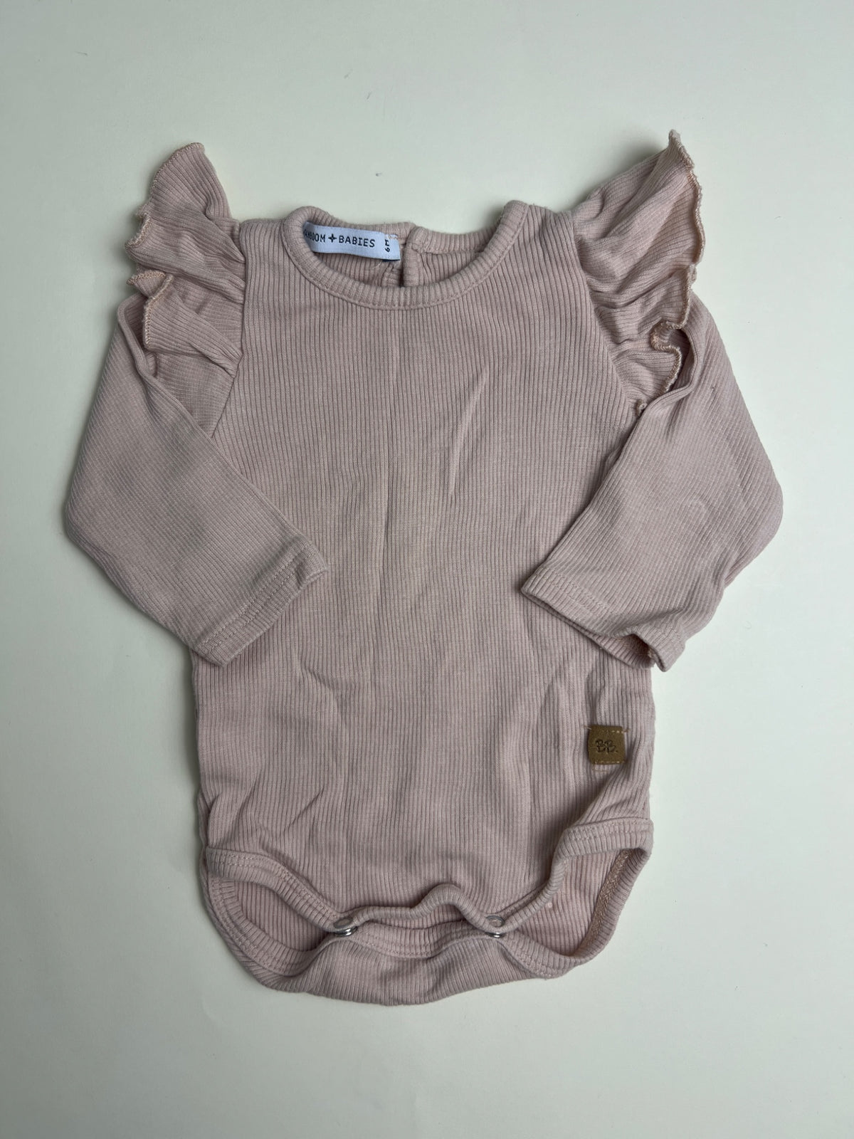 Body neonato a costine rosa con volant